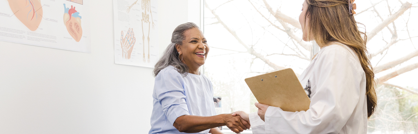 Woman shaking hands with doctor